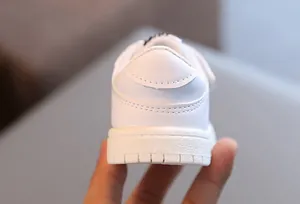 Detailed heel view of white toddler soft-sole walking sneakers for babies aged 0-3 years
