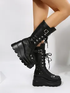 Side view of black punk wedge platform boots with buckles and lace-up details