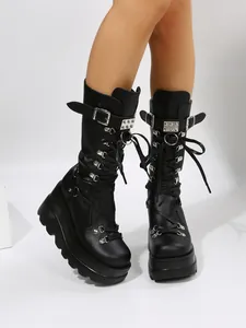 Detailed shot of women's punk style platform boots with silver buckles and studs