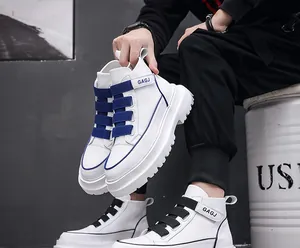 Detail view of men's white high-top sneakers with blue and black strap accents