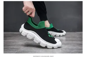 Close-up of men's black and green knitted sock shoes with chunky white sole detail