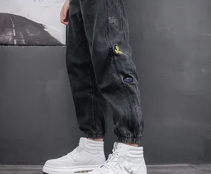 Close-up of white mid-top sneakers paired with dark grey joggers for a trendy urban look