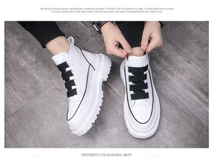 Detail view of men's white high-top boots with black buckle straps and chunky sole