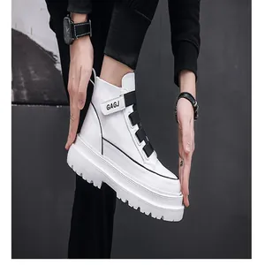 Close-up of men's white high-top fashion sneakers with black decorative strap buckle