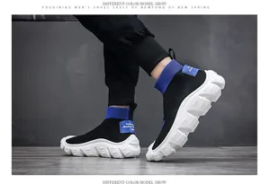 Close-up of black men's flyknit sock sneakers with blue accents and white soles