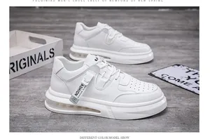 Close-up of white mid-top casual sneakers with stylish strap detail and thick sole