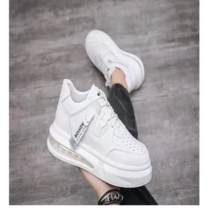 Detailed view of white men's mid-top casual sneakers with platform sole and side tag