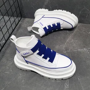 Detail view of white high-top sneakers with blue elastic straps and thick sole.