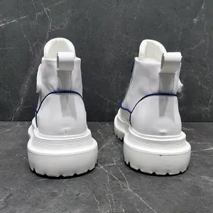 Rear view detail of white men's high-top shoes with blue trim and thick platform sole