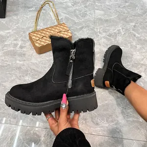 Detailed view of black suede snow boots with warm faux fur lining and side zipper.