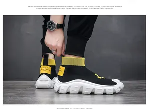 Detailed close-up of men's black fly-knit sock shoes featuring chunky white soles