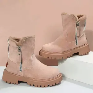 Detail of pink suede snow boots featuring side zipper and warm fur lining