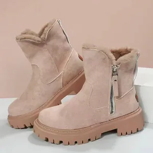 Detail of beige suede snow boots with faux fur lining and side zipper for winter warmth