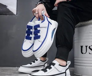 Detail of trendy men's sneakers featuring blue velcro straps and air cushion sole