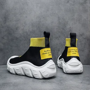 Stylish mens fly-knit sock sneakers with thick white platform soles and yellow accents.