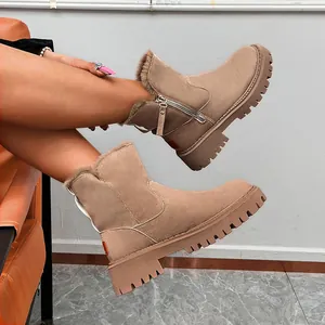 Close-up of khaki fur-lined winter boots featuring a side zipper and a thick lug sole.