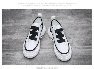 Top view of white men's fashion sneakers with triple black straps and thick soles.