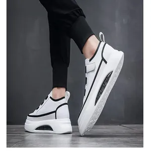 Detail view of men's white chunky sneakers with black trim and air cushion sole.
