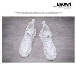 Detailed top-view of white high-top men's sneakers on a grey textured background