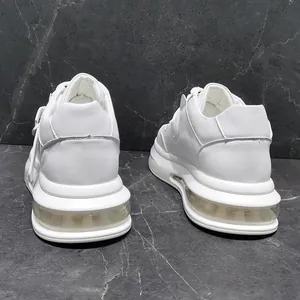 Detailed rear view of white mid-top fashion sneakers with thick cushioned soles