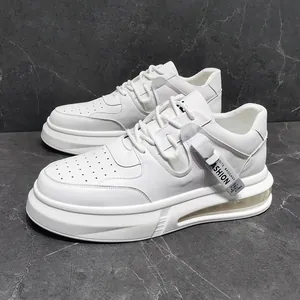 Sleek white platform men's casual sneakers featuring a decorative side strap on marble background