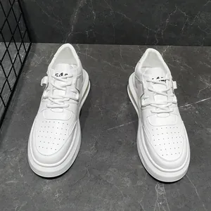 Close-up detail of stylish white mid-top men's casual sneakers on grey marble floor