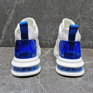Rear view of white men's sneakers featuring a royal blue air cushion and heel accents.