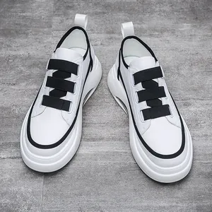 Stylish white men's sneakers with black velcro straps and air cushion sole.