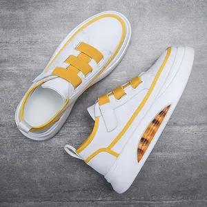 Stylish men's white sneakers with yellow accents and visible air cushion sole.
