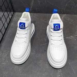 Pair of white men's casual sneakers with soft soles and blue tongue accents