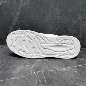 Detailed view of the white anti-slip outsole on a pair of men's casual sneakers.