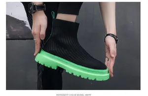 Detail view of men's high-top knit sock shoes with vibrant neon green platform sole