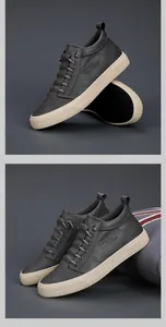 Dettaglio di sneaker alte da uomo grigio scuro con suole spesse color crema.