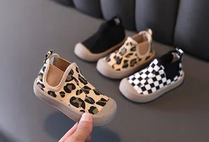 Detail view of boy's leopard and checkerboard pattern mid-top canvas shoes with warm padding