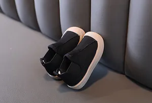 Side view of children's black canvas mid-cut shoes with warm lining and rubber sole