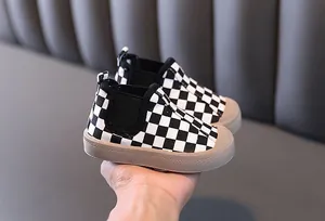 Close-up of checkered canvas shoes for boys with warm lining and thick rubber sole