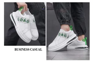 Close-up view of white men's casual slip-on sneakers featuring green letter patterns