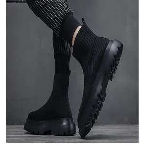 Close-up view of black high-top fly-knit sock shoes for men with thick lug sole