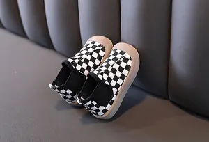 Detail macro view of children's black and white checkerboard warm canvas walking shoes