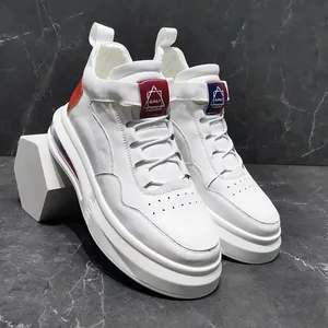 Detailed view of white high-top men's sneakers with air cushion soles and red accents.