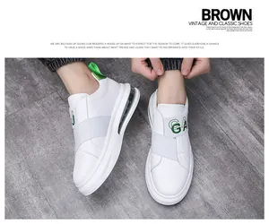 Detail view of mens white slip-on sneakers with gray elastic band and air cushion.