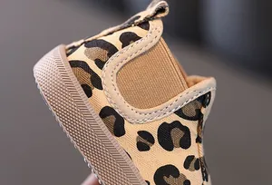 Detailed close-up view of leopard print canvas shoes for boys with durable rubber sole.