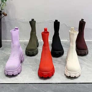 Detailed display of colorful knitted high-top sock boots with chunky lug soles