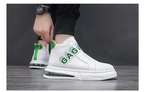 Detailed side view of men's white high-top sneakers with green accents and air cushion