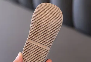 Detailed view of non-slip wave texture on the sole of toddler's padded canvas shoes