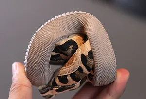 Close-up showing the flexible rubber sole of leopard print kids canvas shoes