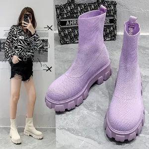 Close-up view of purple fly-knit platform sock boots with chunky lug sole for women