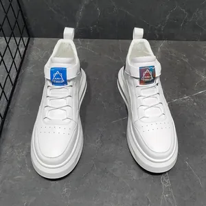 Detail of white men's fashion sneakers with iridescent logo strap and thick sole