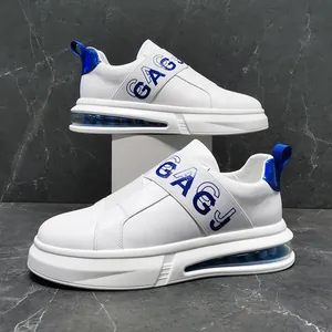 Close-up of white slip-on men's sneakers with blue elastic strap and air cushion.
