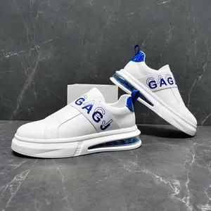 Detail view of white men's slip-on sneakers with blue GAGJ elastic strap and air cushion.